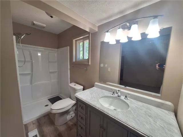 This bathroom features a contemporary vanity and shower, enhancing daily routines.