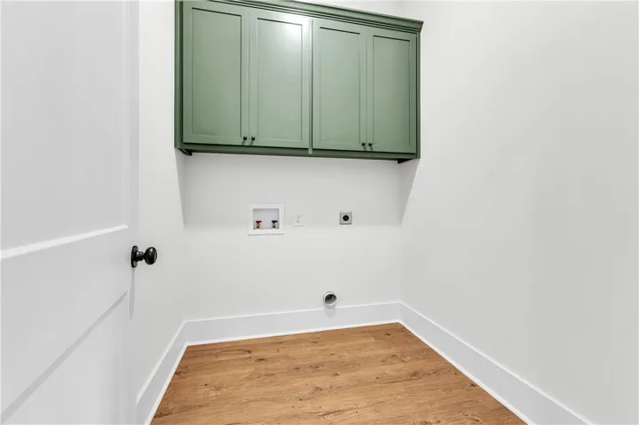Ample cabinetry and durable flooring create a functional and organized utility space.