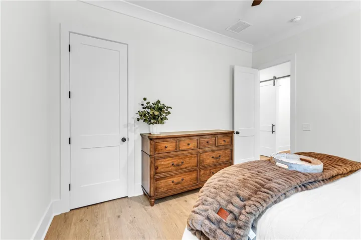 Blonde hardwood floors complement bright walls and classic white doors.