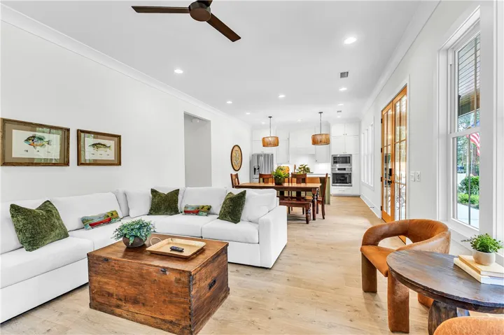 An inviting open floorplan seamlessly connects the living area, dining space, and kitchen.