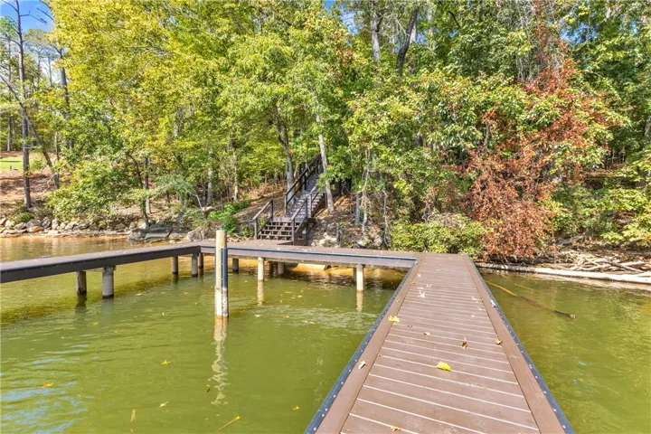 This serene lakefront property boasts a private dock, offering direct water access for recreation.