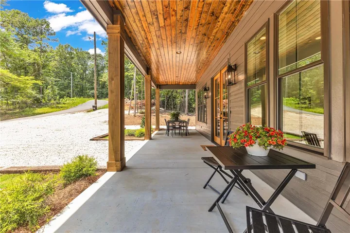 An inviting covered patio offers a tranquil outdoor retreat with ample space for entertaining.
