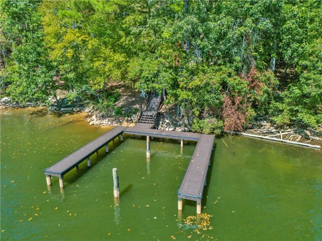 This serene lakefront property offers direct access to the water with a private dock.