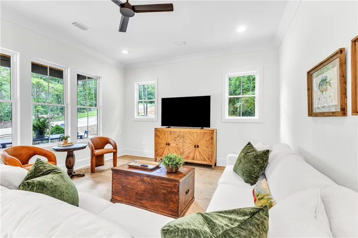 A tranquil living space featuring abundant natural light and rich wood flooring.