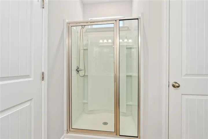 A well-appointed shower stall, perfect for daily routines, features clean lines and a functional design.