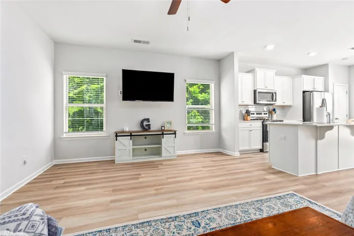 Bright living room with great natural light and easy flow into the kitchen and dining areas.