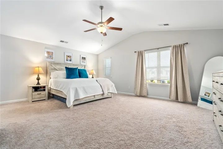 Spacious primary suite with room for a king bed and additional furniture.