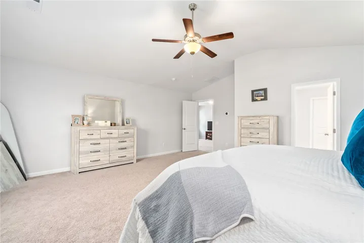Spacious primary suite with room for a king bed and additional furniture.