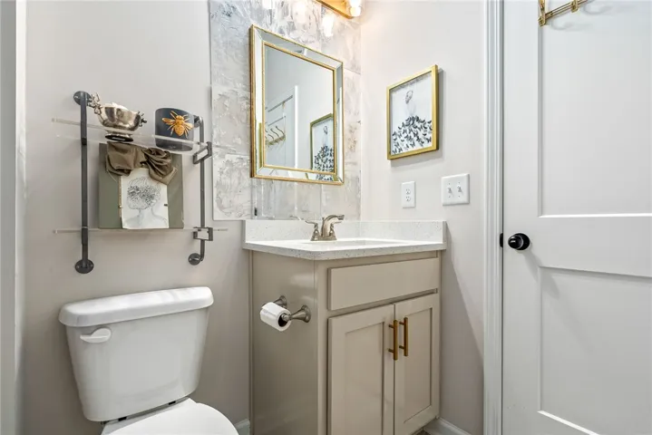 This thoughtfully designed bathroom offers a functional vanity with ample storage and a sleek counter.