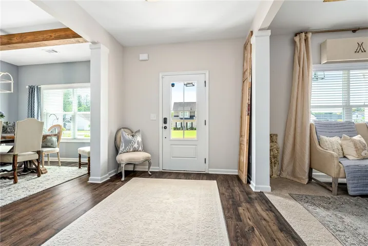 An inviting entry opens into bright living spaces with beautiful flooring.