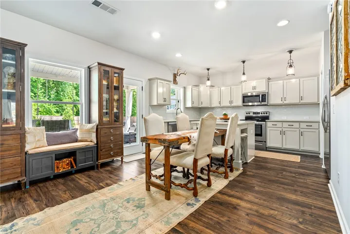 This open concept space features a kitchen with an island, ideal for gathering and daily living.