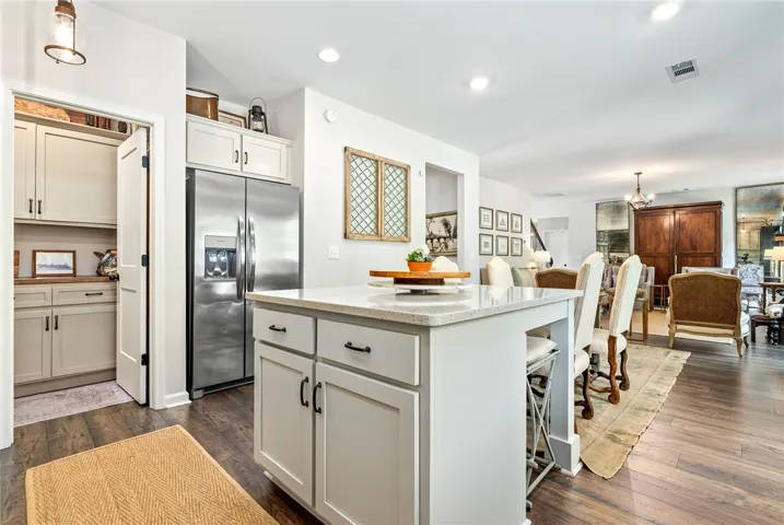 This spacious kitchen offers ample storage, a large island, and opens to a dining area.