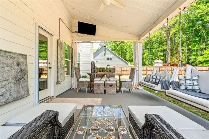 This inviting covered patio offers a comfortable space for outdoor enjoyment and relaxation.