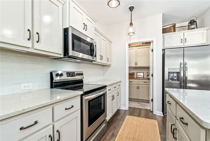This modern kitchen features sleek countertops and appliances, ideal for culinary pursuits.