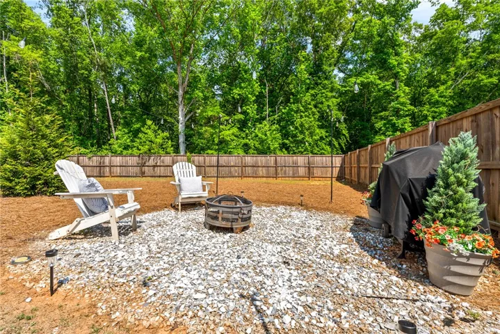 This spacious yard offers a private retreat with ample space for relaxation and outdoor enjoyment.