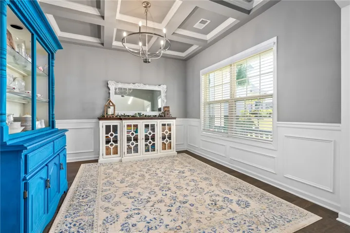 This spacious dining area features elegant wainscoting and abundant natural light.