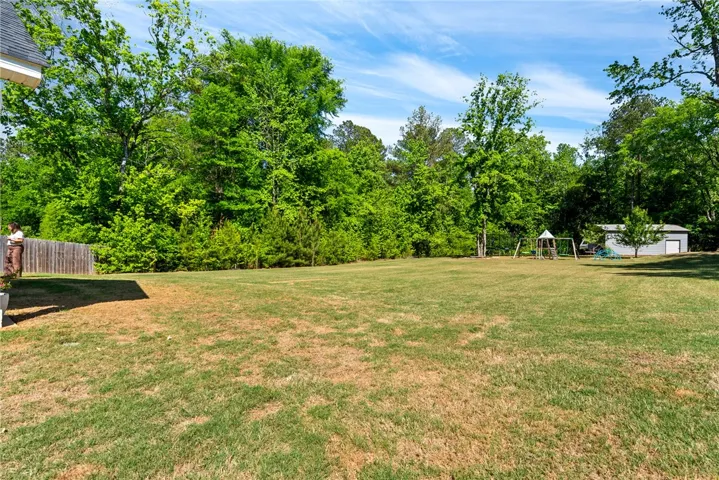 This spacious backyard provides ample room for outdoor activities and future enhancements.