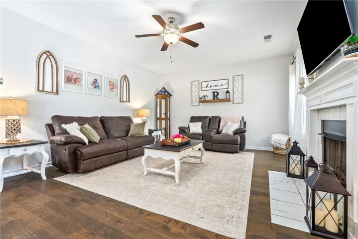 This inviting living room features rich hardwood flooring and a cozy fireplace, perfect for relaxation.