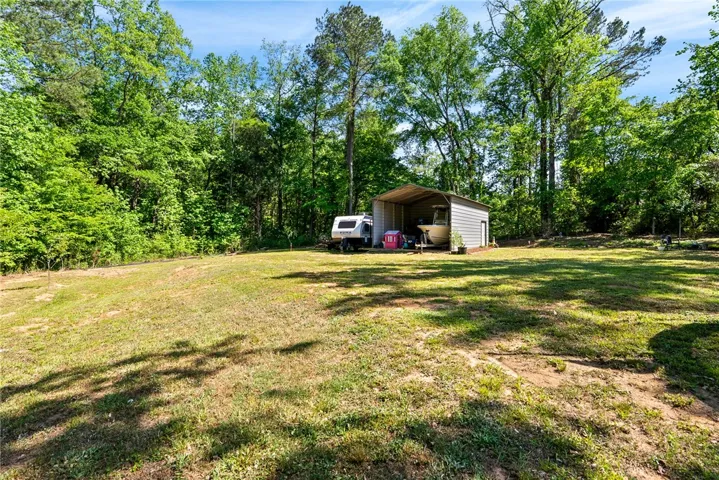This spacious yard offers ample green space and a convenient shed for storage.