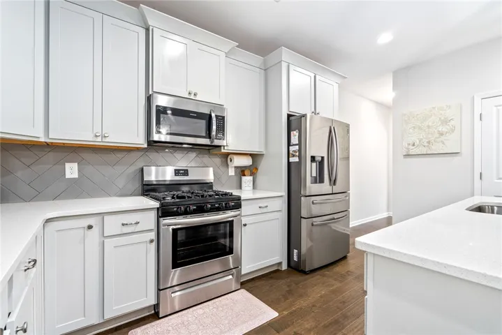 This modern kitchen features stainless steel appliances and abundant cabinetry, offering both style and functionality.