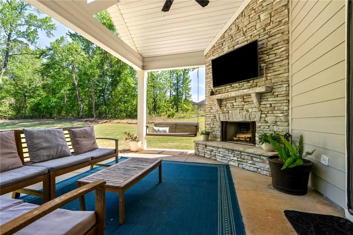 An inviting outdoor living area with a cozy fireplace for relaxed gatherings.