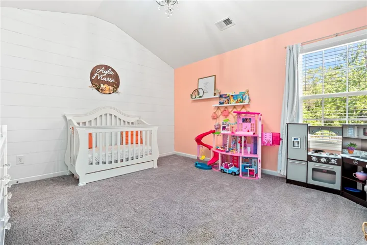 This cheerful bedroom offers a bright and inviting space for rest and play.