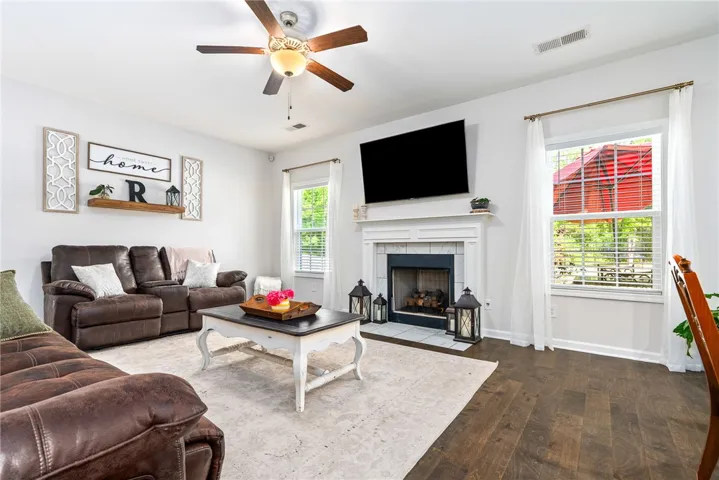 This inviting living space features hardwood flooring and a cozy fireplace, ideal for relaxation and entertaining.