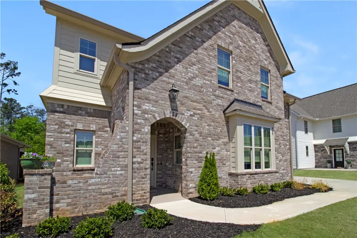 This two-story brick residence showcases a captivating blend of classic and modern architectural details.