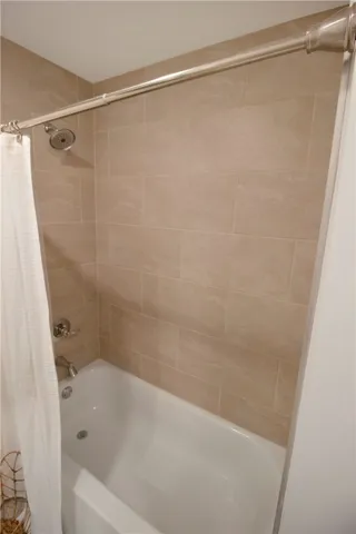 This sleek shower and tub combination offers a clean and inviting bathing experience.