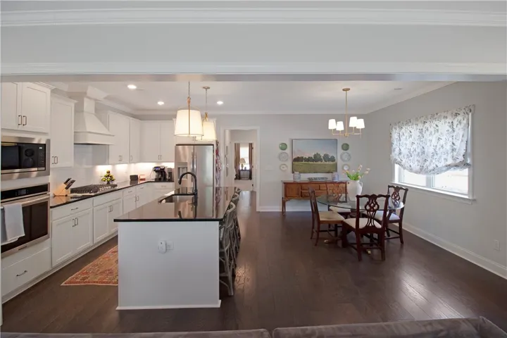 This open concept kitchen and dining area provides a seamless entertaining space with modern finishes.