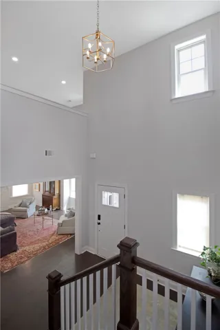 This bright and airy foyer offers a grand welcome, seamlessly connecting to elegant living spaces.