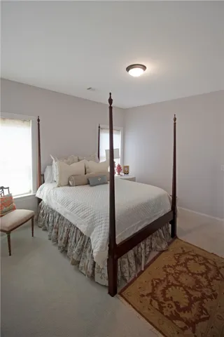 This inviting bedroom offers comfort and style with ample natural light.