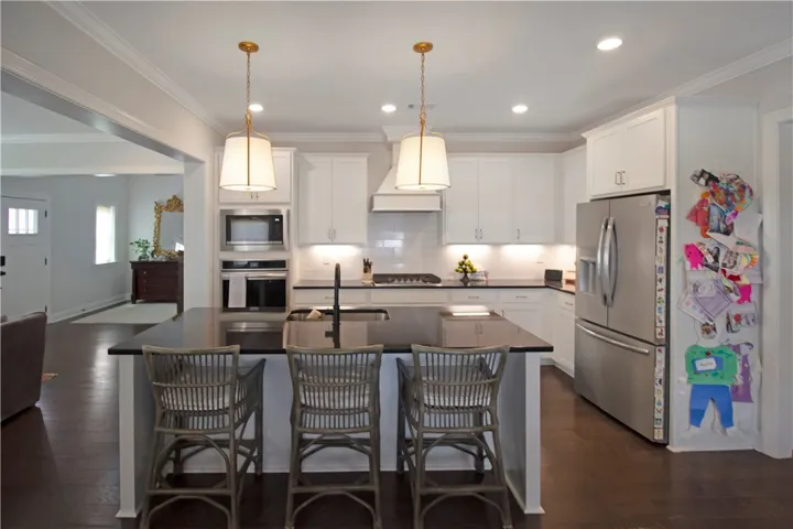 This modern kitchen features a spacious island and sleek stainless steel appliances.