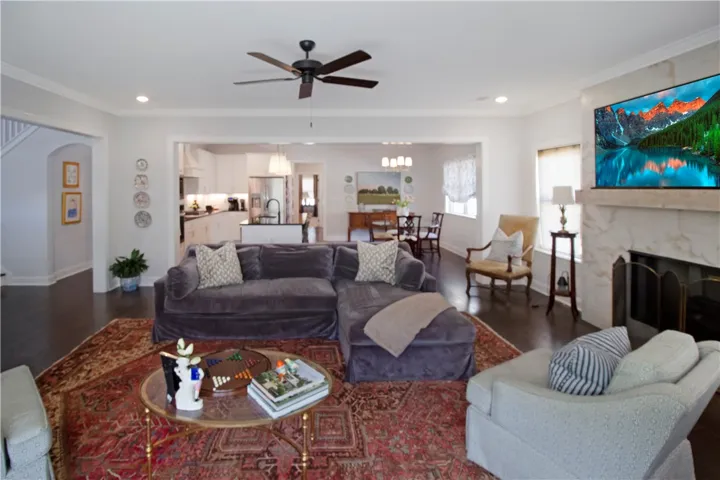This inviting living area boasts an open floorplan with hardwood floors and a cozy fireplace.