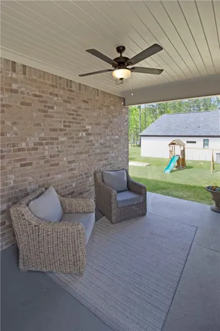 This covered patio offers a comfortable outdoor retreat with easy access to a spacious yard.