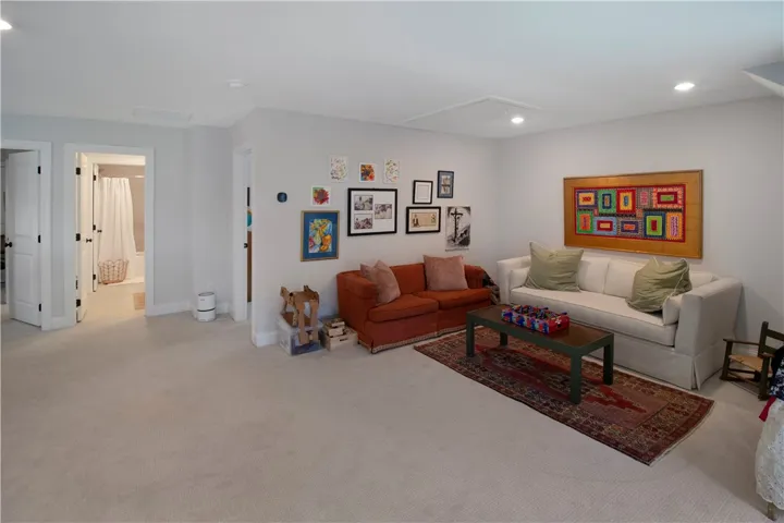 This versatile bonus room offers ample space for recreation and relaxation, complemented by recessed lighting.