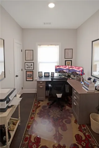 An inviting home office with ample natural light, creating an ideal workspace.