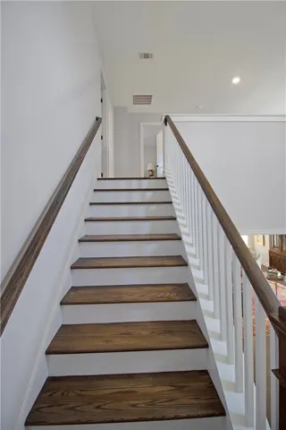 Ascend to comfort with elegant hardwood stairs and classic white risers, perfect for any home.
