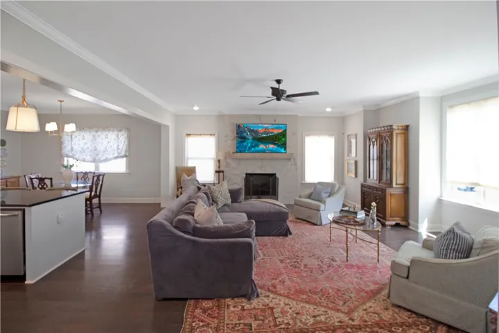 This inviting space features an open layout with a fireplace and ample natural light.