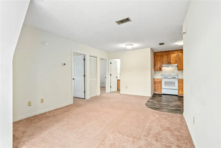 A compact open-concept living area seamlessly connects to an efficient kitchen space, offering practical living.