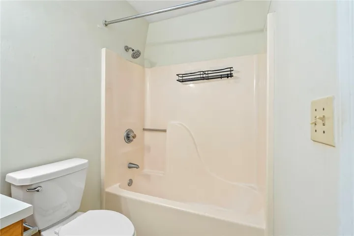 A well-maintained bathroom featuring a practical shower-tub combination for daily convenience.