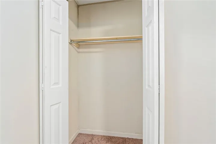 Functional closet space offers convenient garment storage and organizational possibilities.