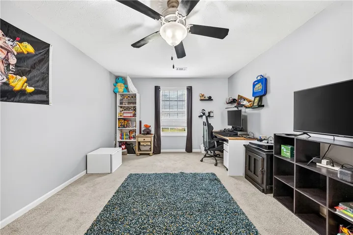 This spacious room features a large window and ample space for various activities.