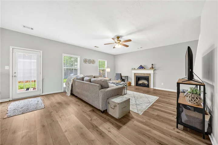 This inviting living room offers comfortable living with a charming fireplace.