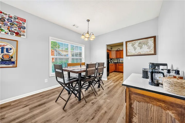 This inviting dining area features durable flooring and ample natural light, perfect for everyday meals.