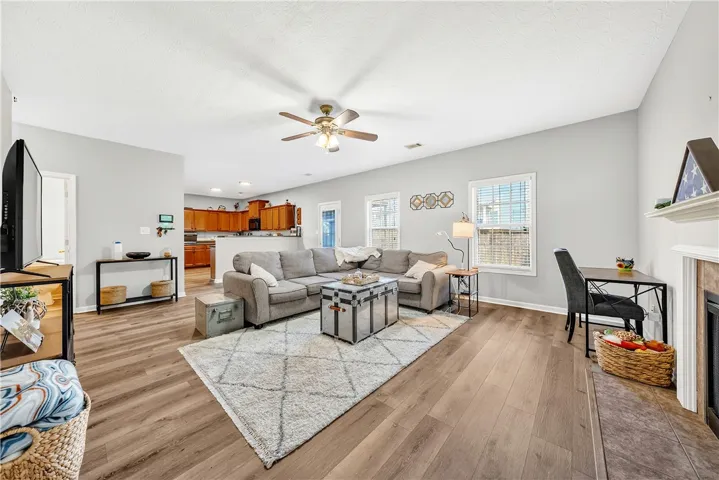 This inviting space features an open layout connecting living, dining, and kitchen areas.
