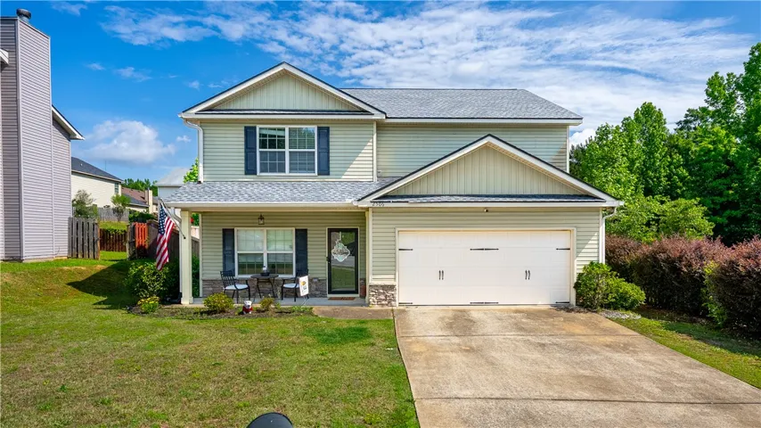 This inviting home offers curb appeal and a convenient attached garage, perfect for modern living.