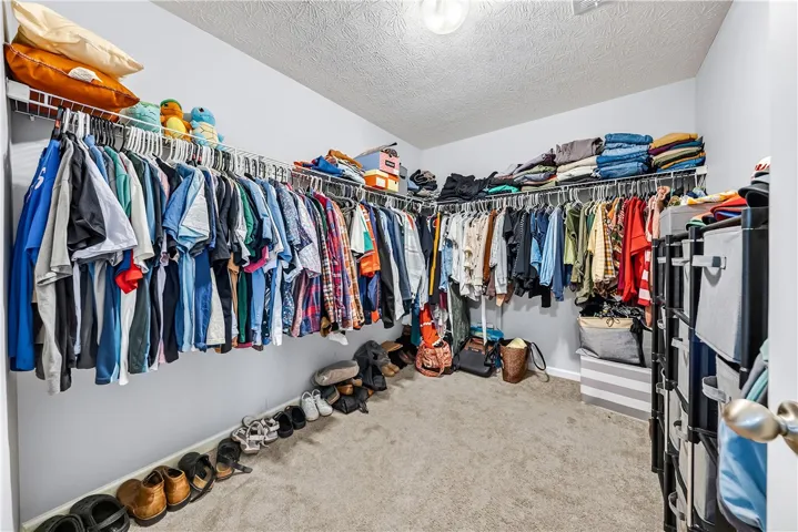 This spacious walk-in closet offers ample storage and organization for your wardrobe.