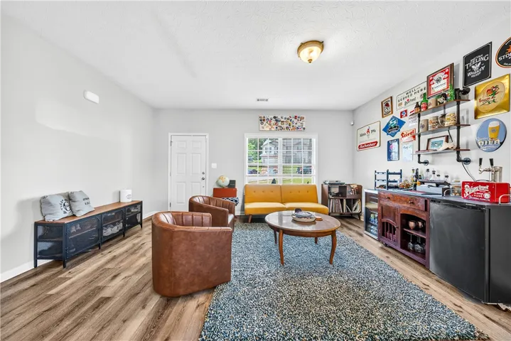 This living room features hardwood flooring and ample natural light, ideal for comfortable living.