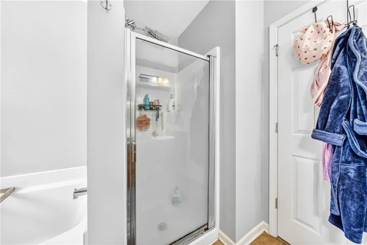 Step into comfort and style within this inviting bathroom featuring a sleek shower.